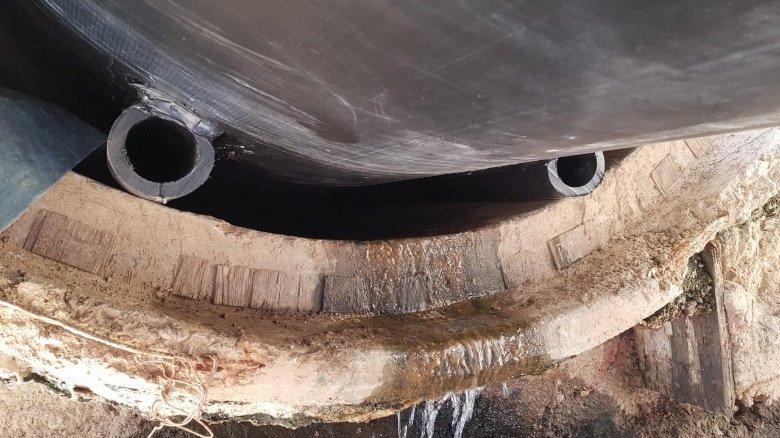 The polyethylene pipe OD 1200 mm slid like a sled on the “runners” into the old concrete pipe.